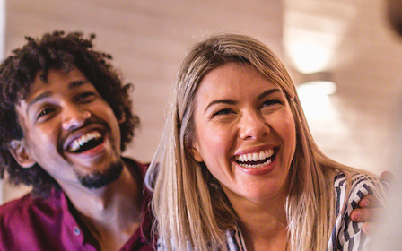 A man and woman laughing.