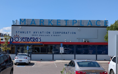 A building with cars parked in front of it.