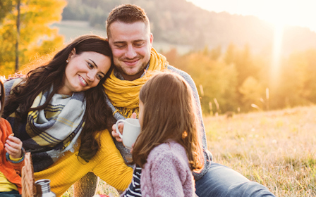 A group of people sitting together outside.