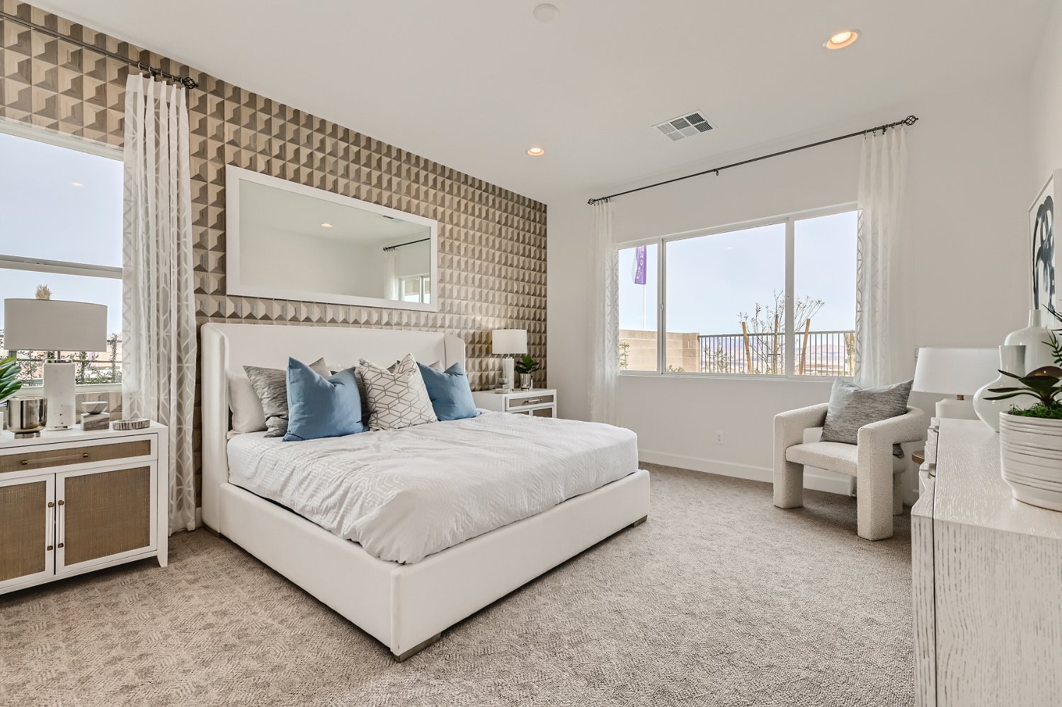 A bedroom with a large window.