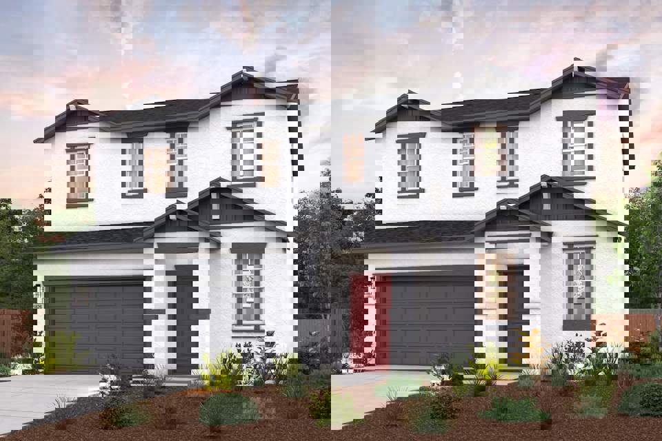 A white house with a garage.