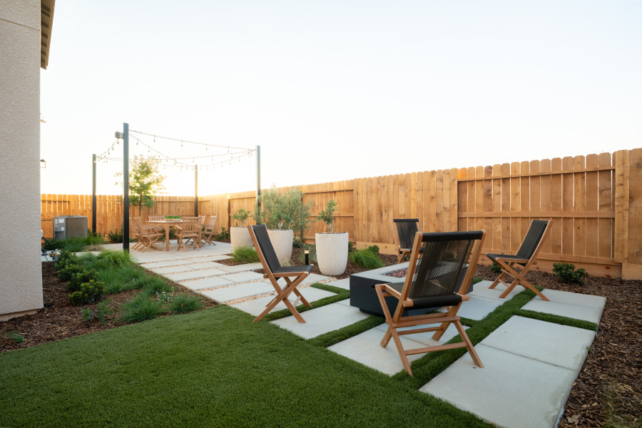 A backyard with chairs and tables.