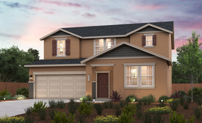 A house with a garage and a garden in front of it.
