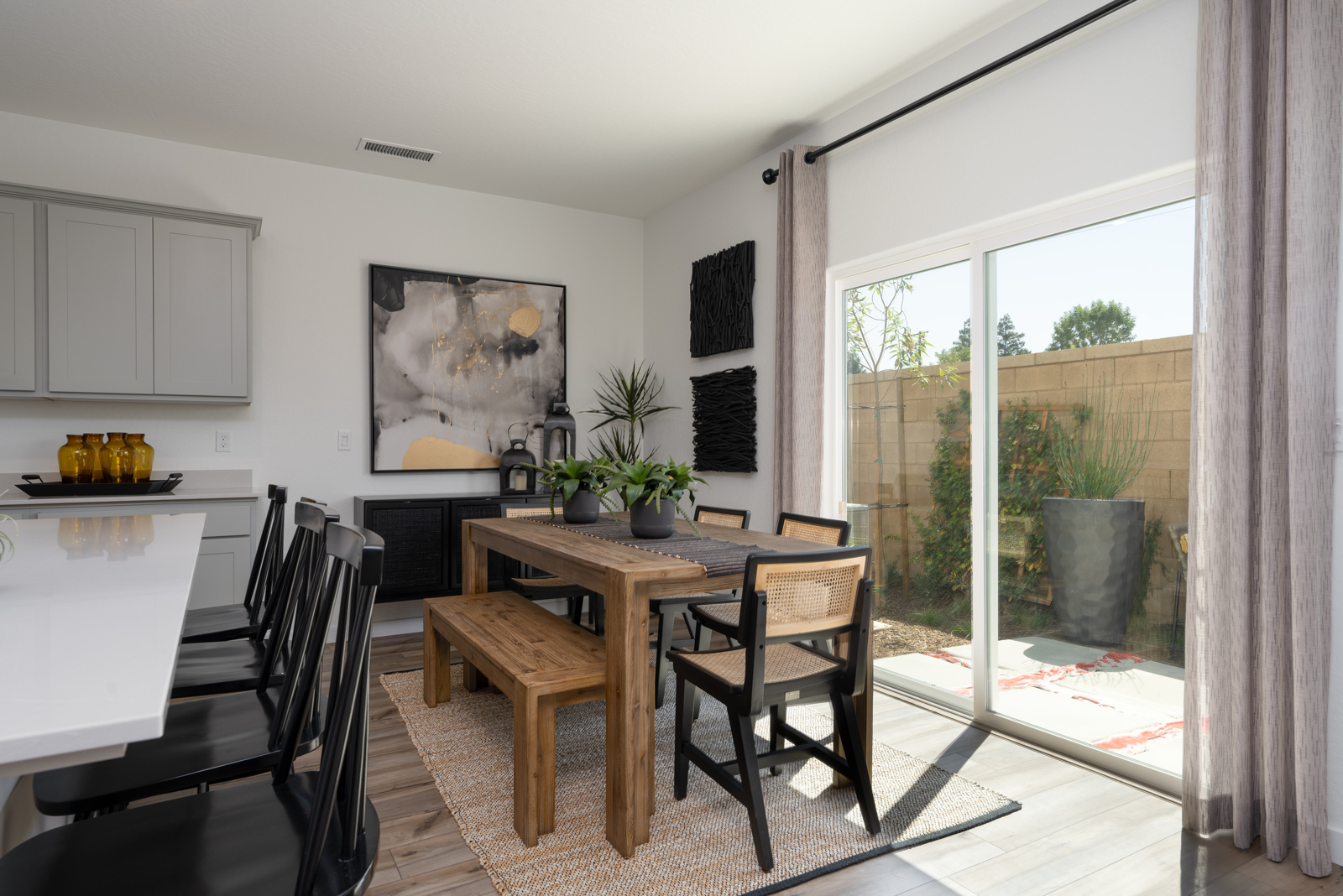 A dining room with a table and chairs.