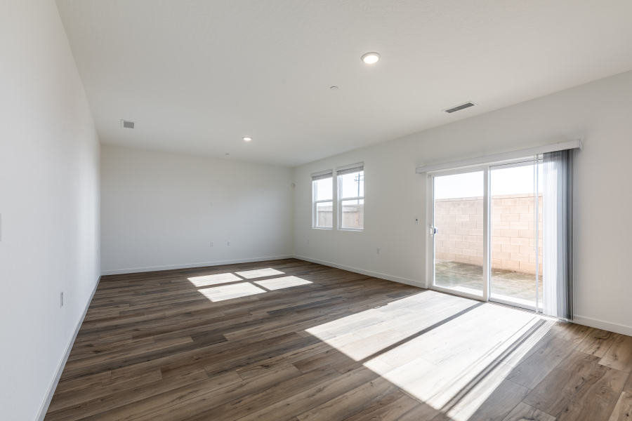 A room with a wood floor and windows.