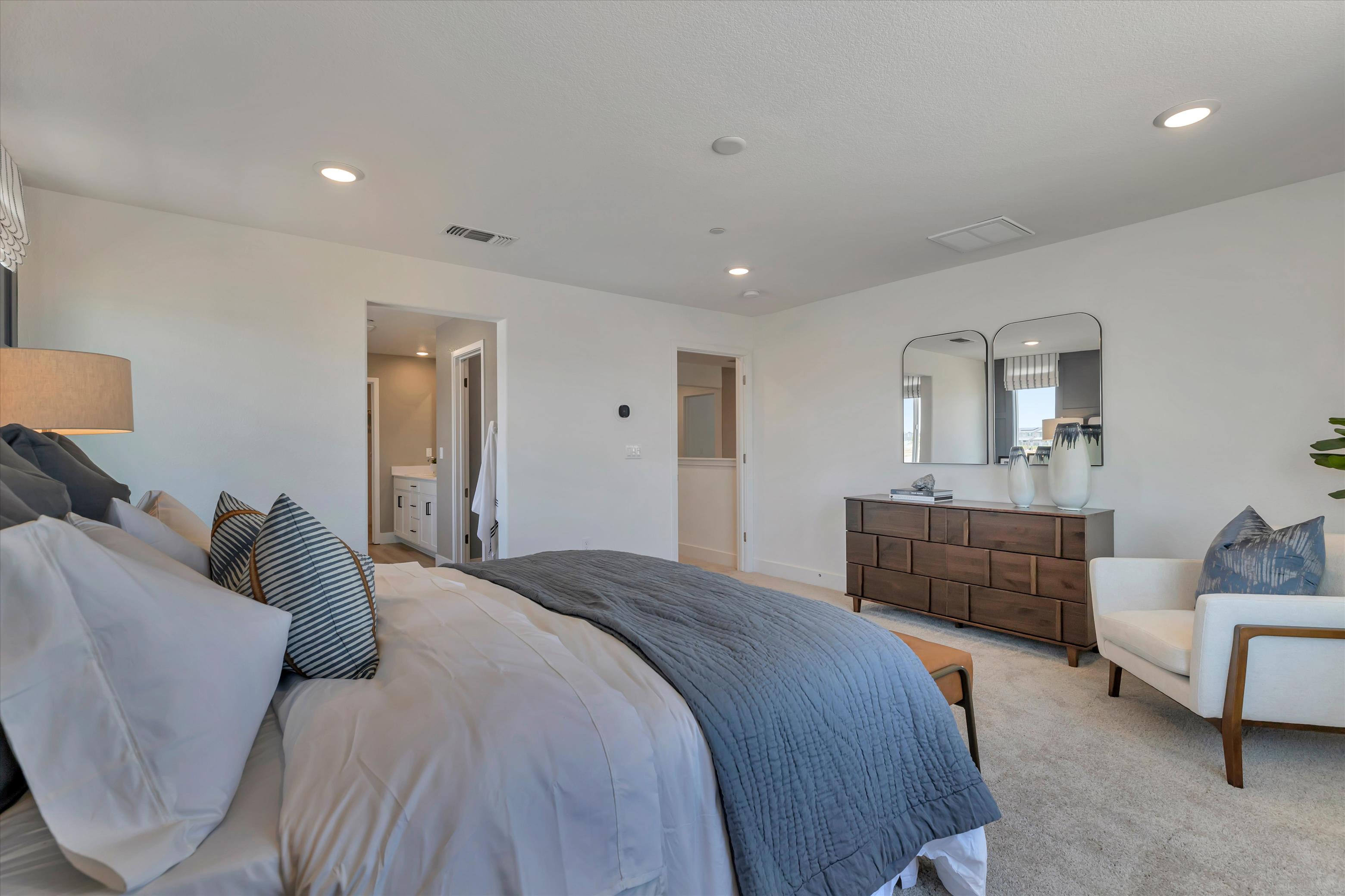 A bedroom with a bed and a couch.