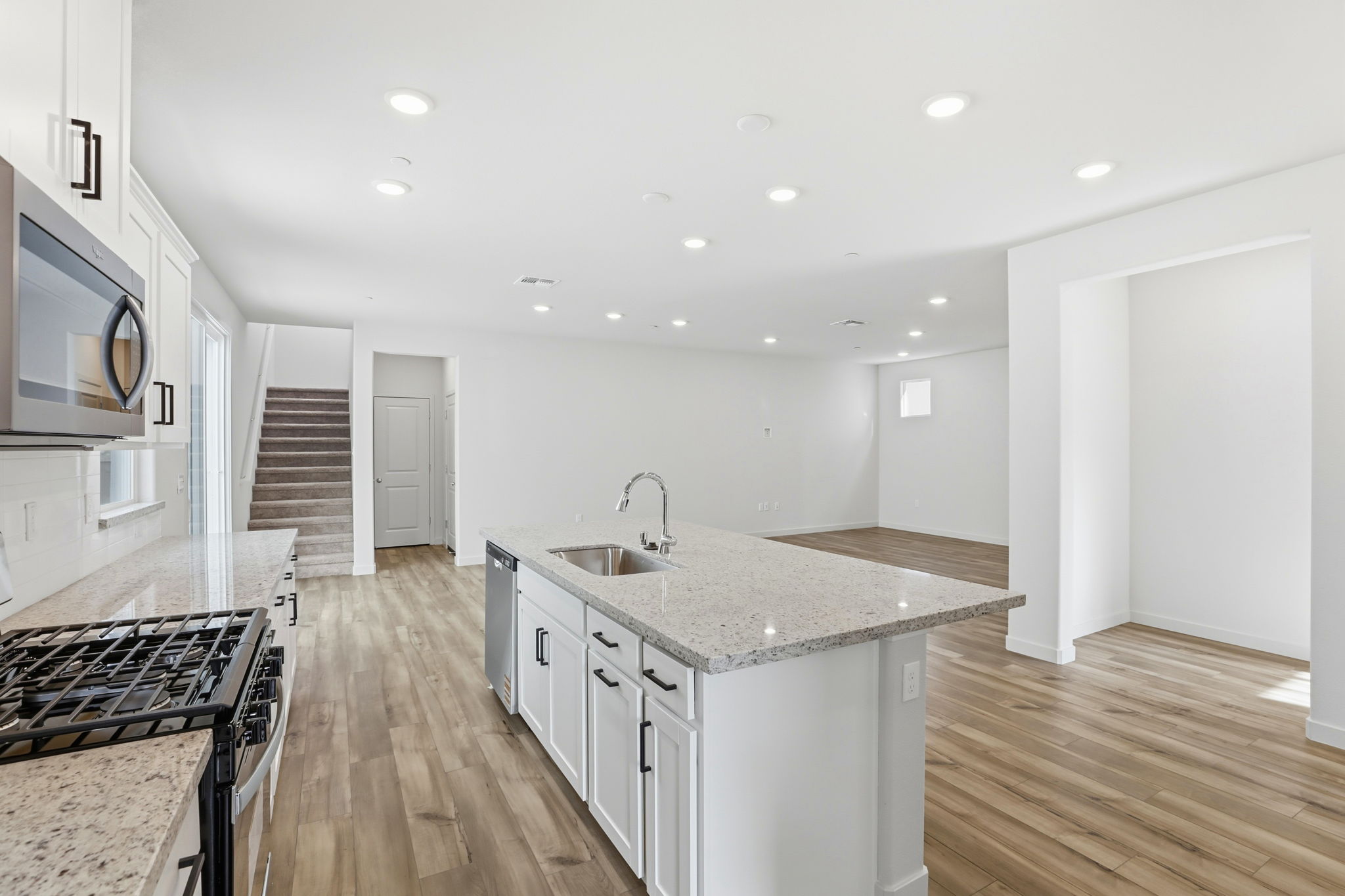 A kitchen with a marble island.