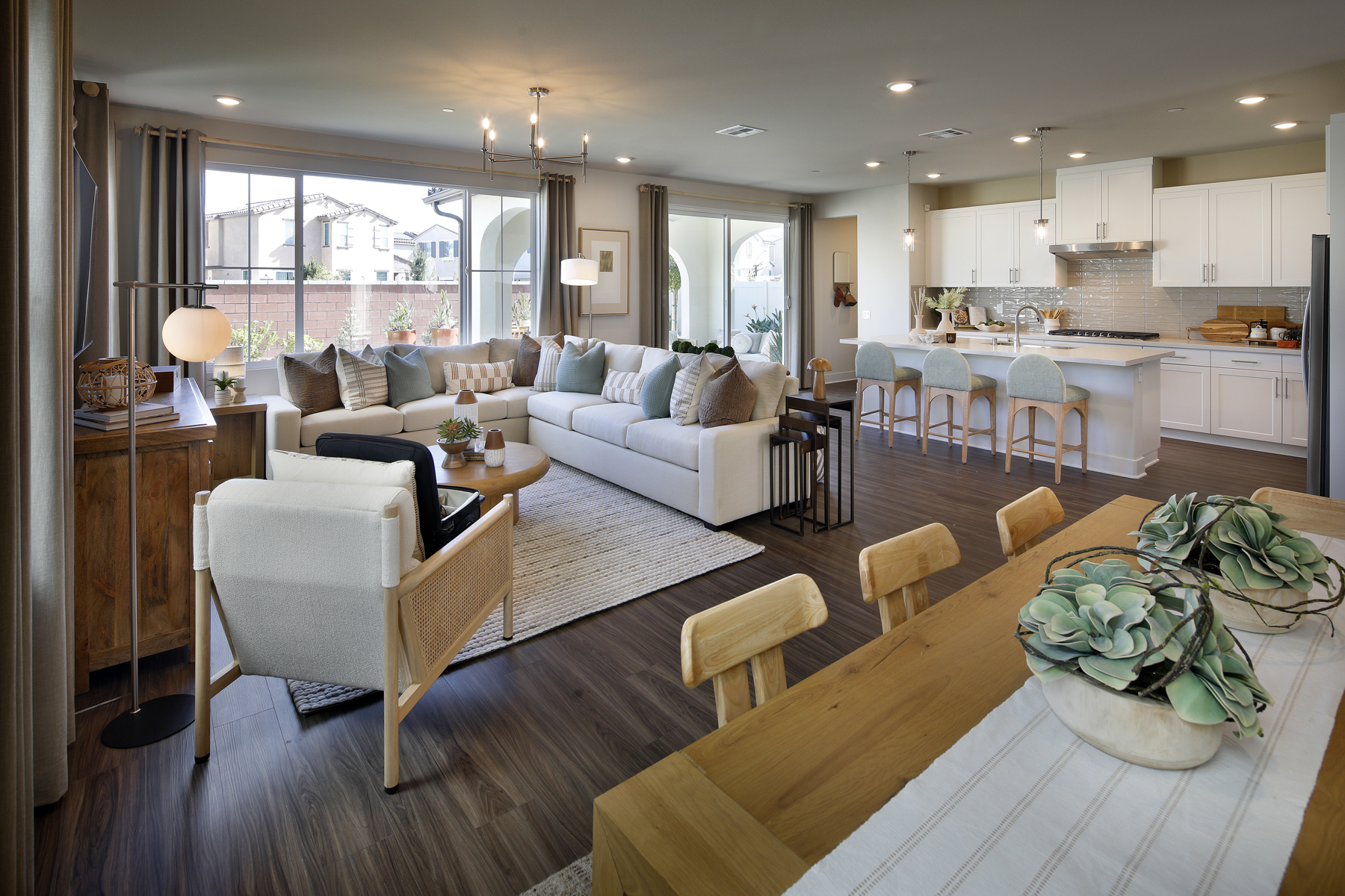 A living room with a large kitchen.