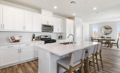 A kitchen with white cabinets.