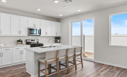A kitchen with white cabinets.