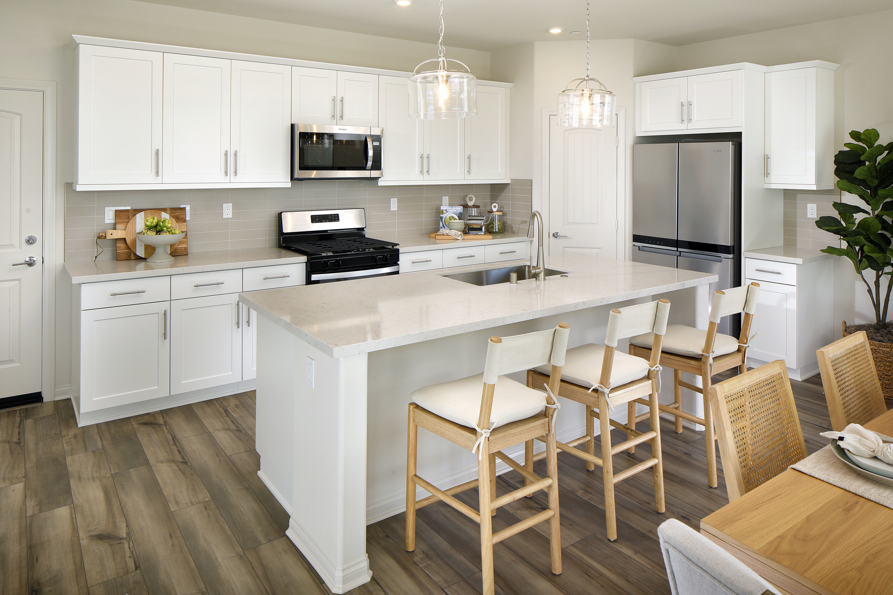 A kitchen with white cabinets.