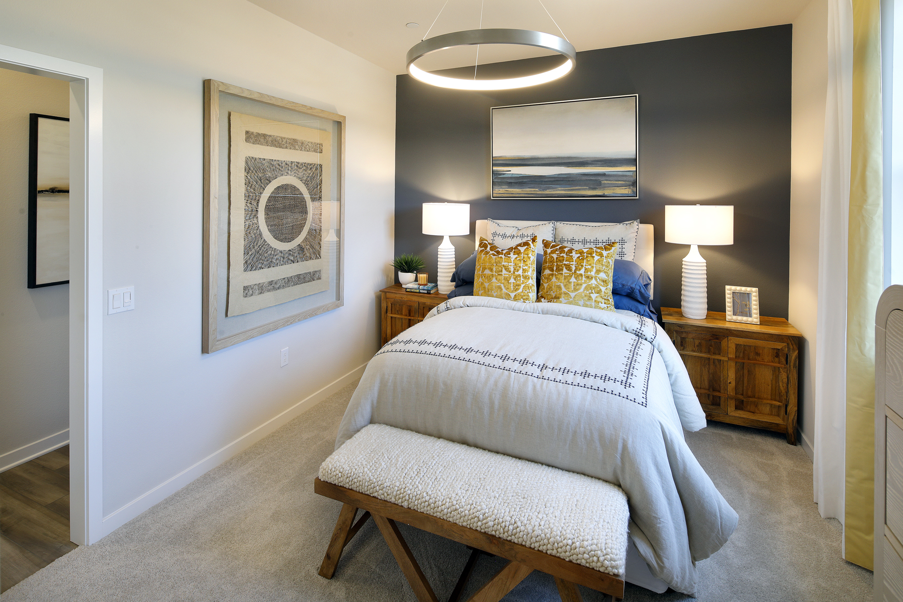 A bedroom with a bed and lamps.