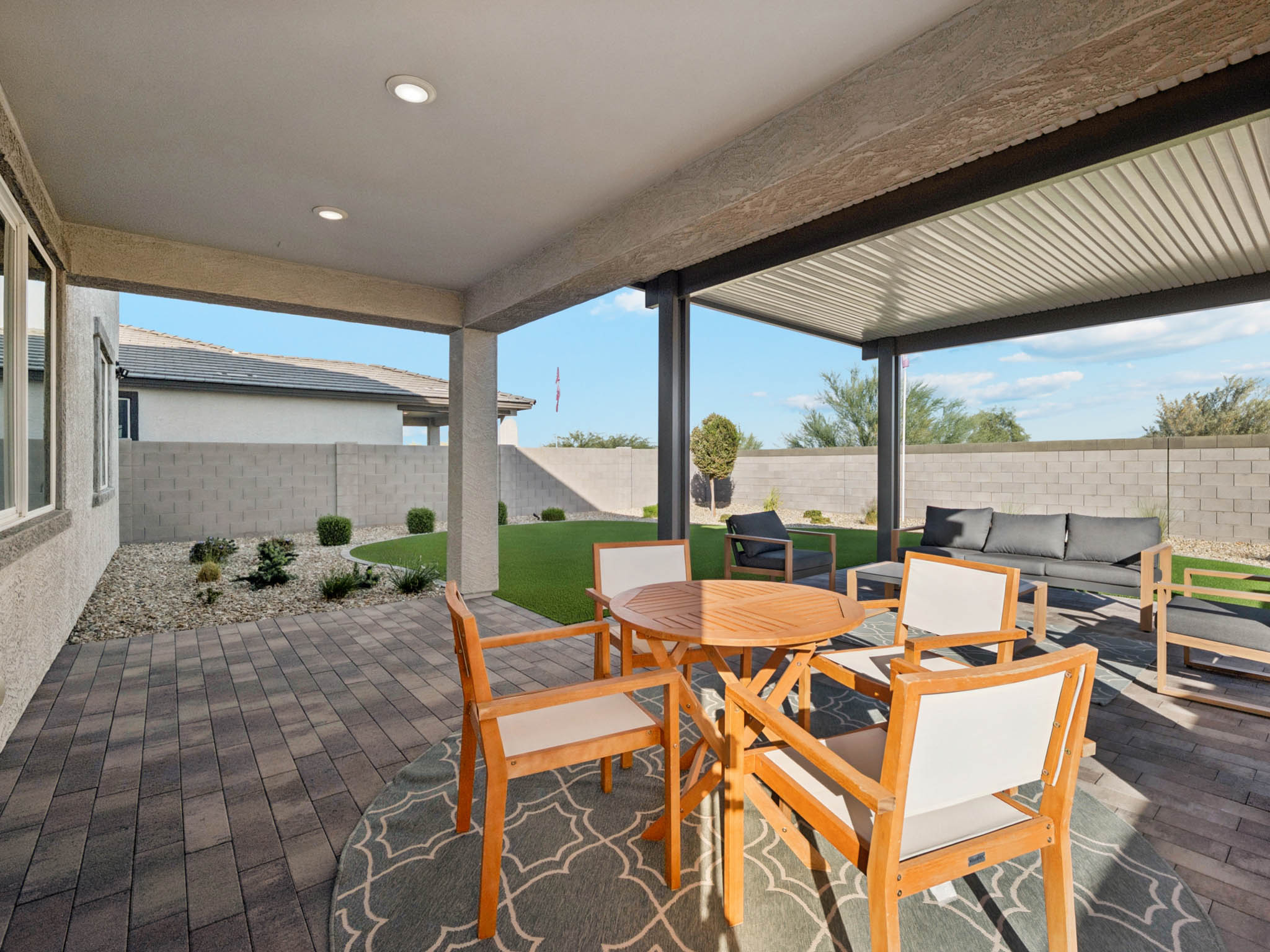 A patio with tables and chairs.