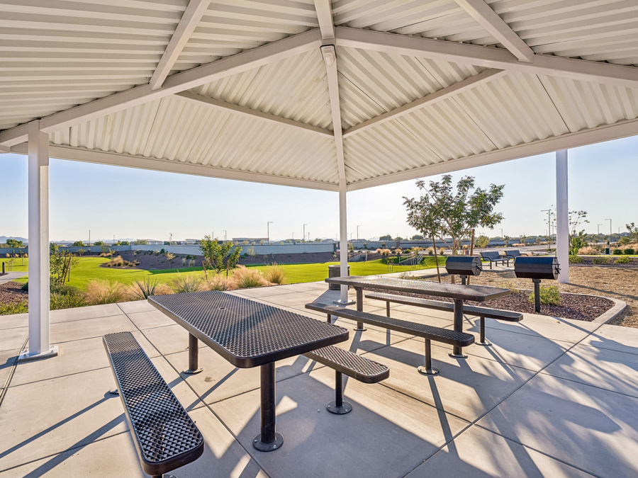 A table and chairs under a tent.