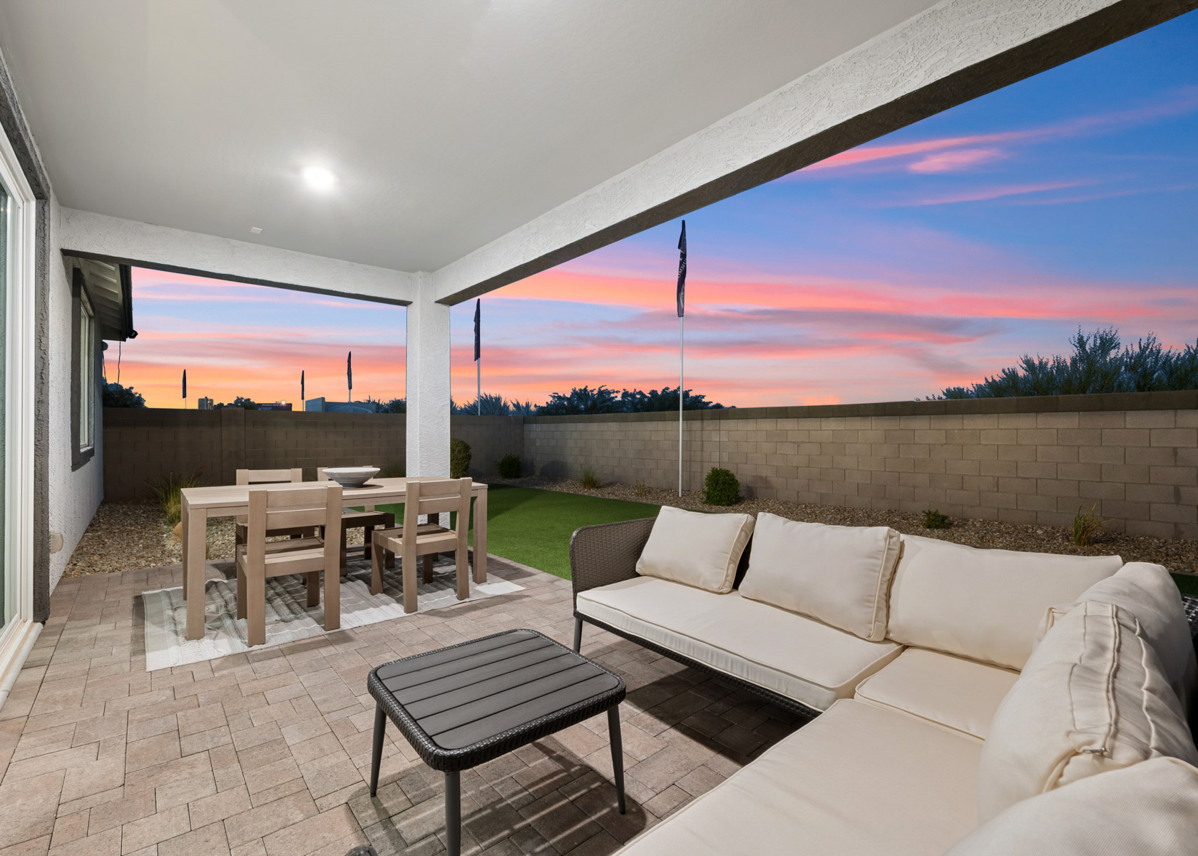 A patio with a table and chairs.