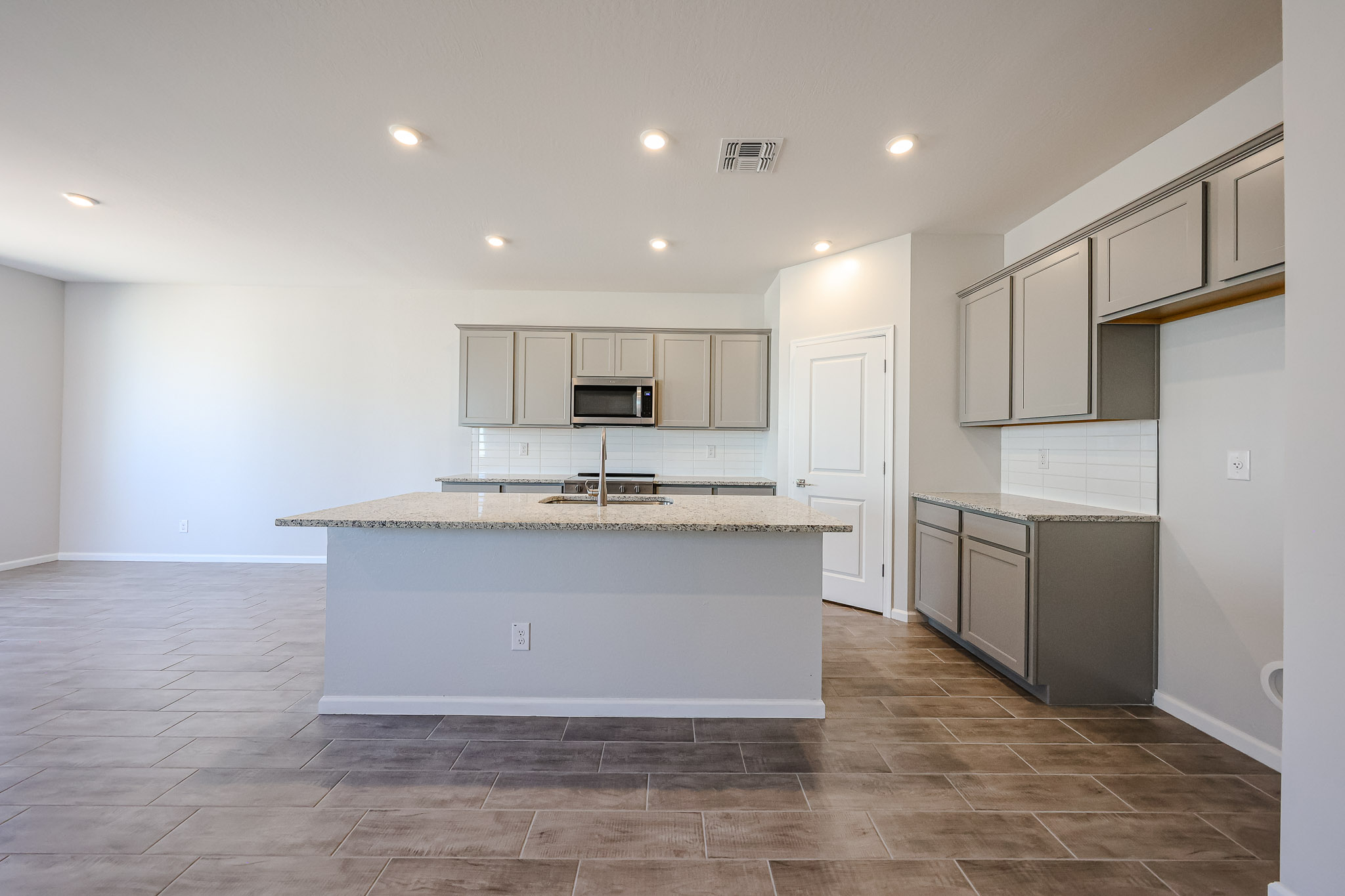 A kitchen with white cabinets.