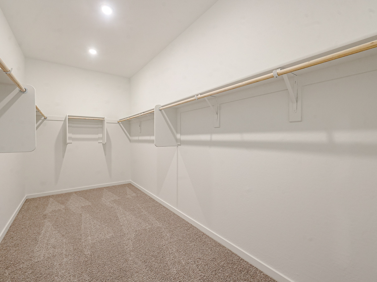 A white wall with a metal bar.