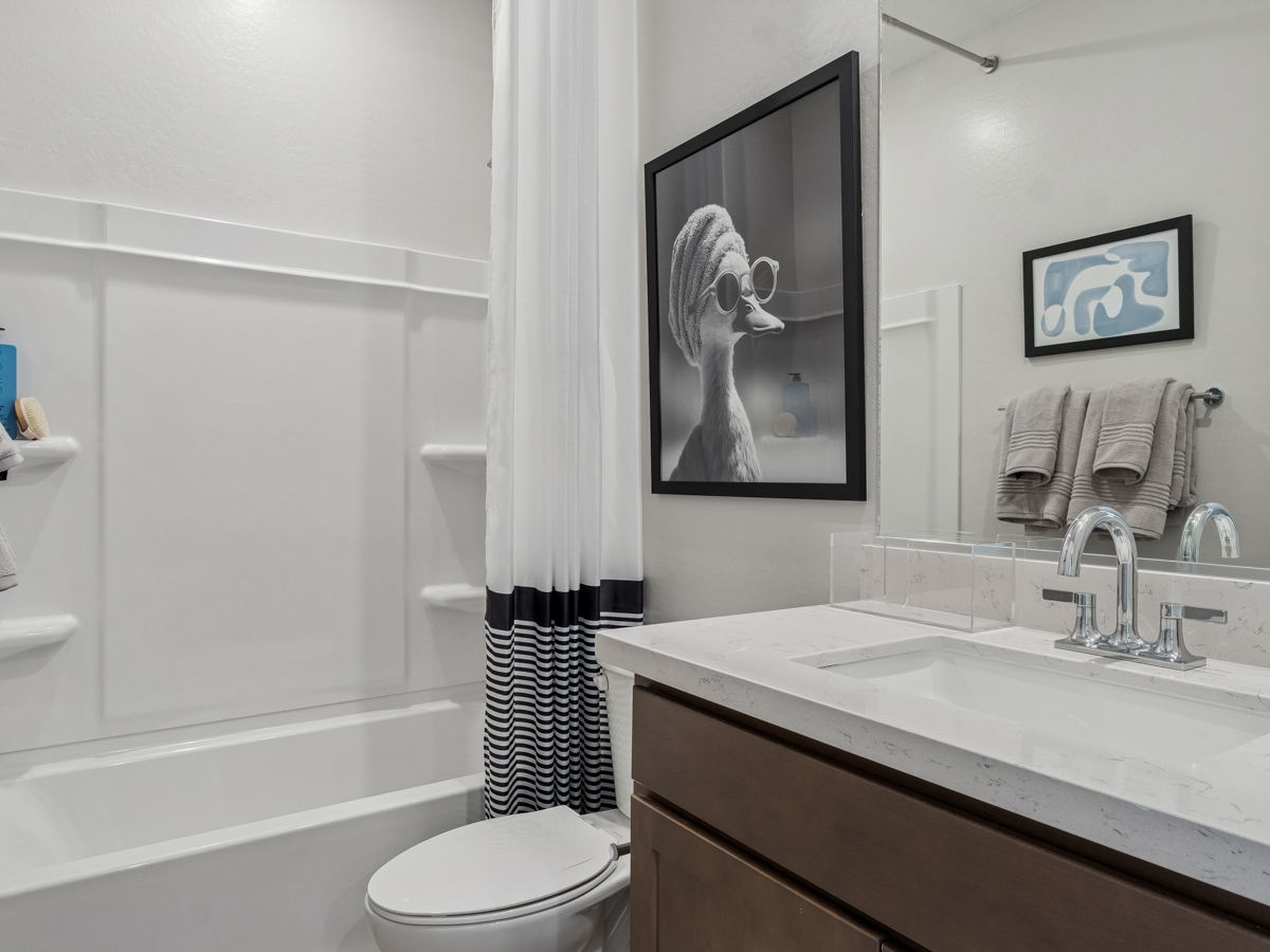 A bathroom with a sink toilet and a bathtub.