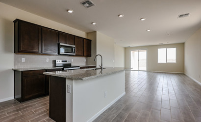 A kitchen with wooden cabinets.
