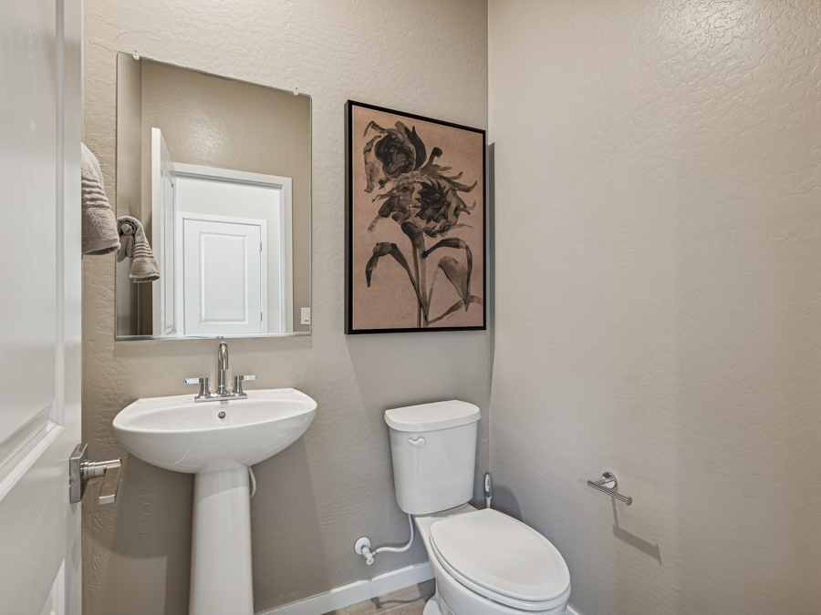 A bathroom with a toilet and sink.