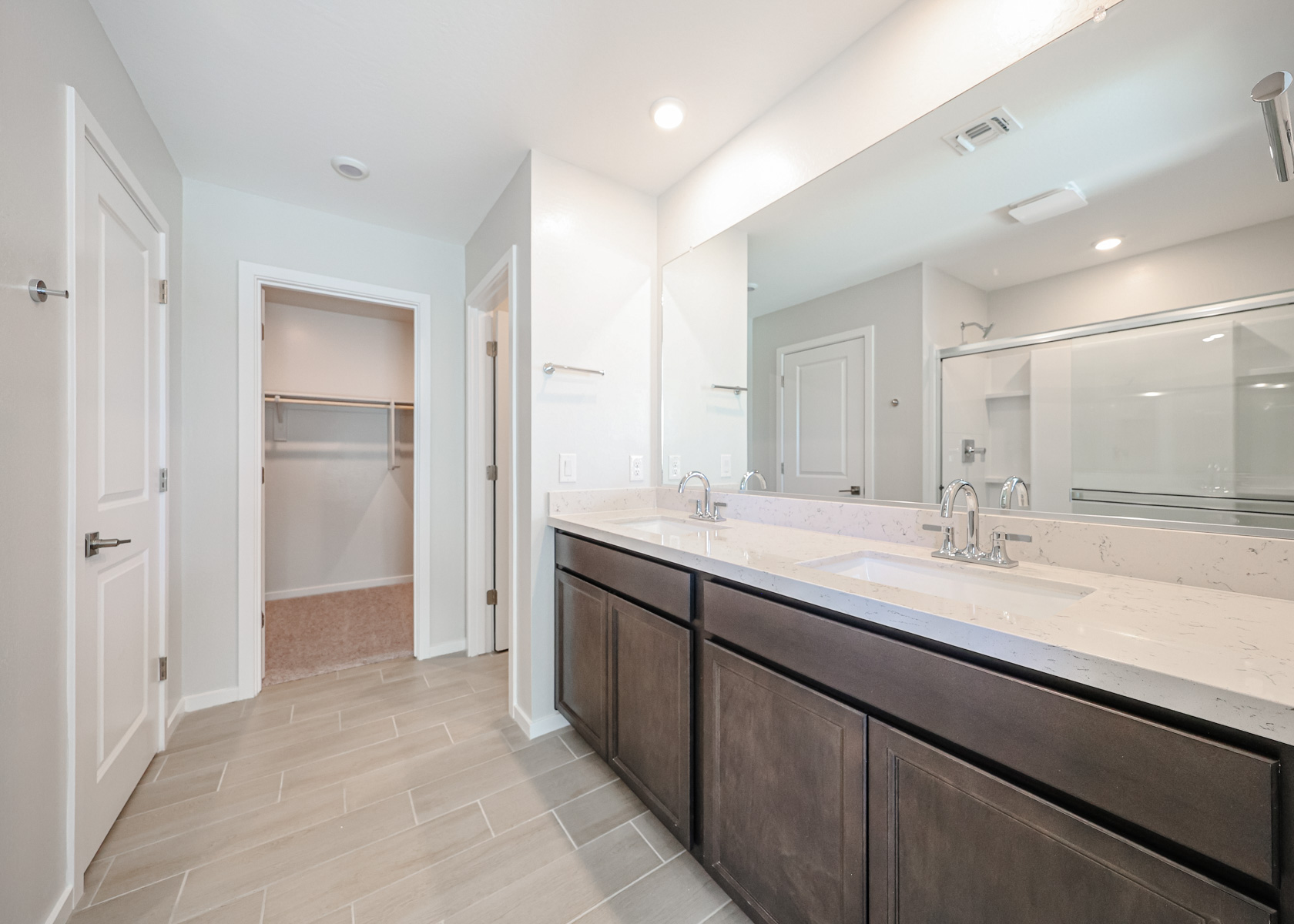 A bathroom with a large mirror.