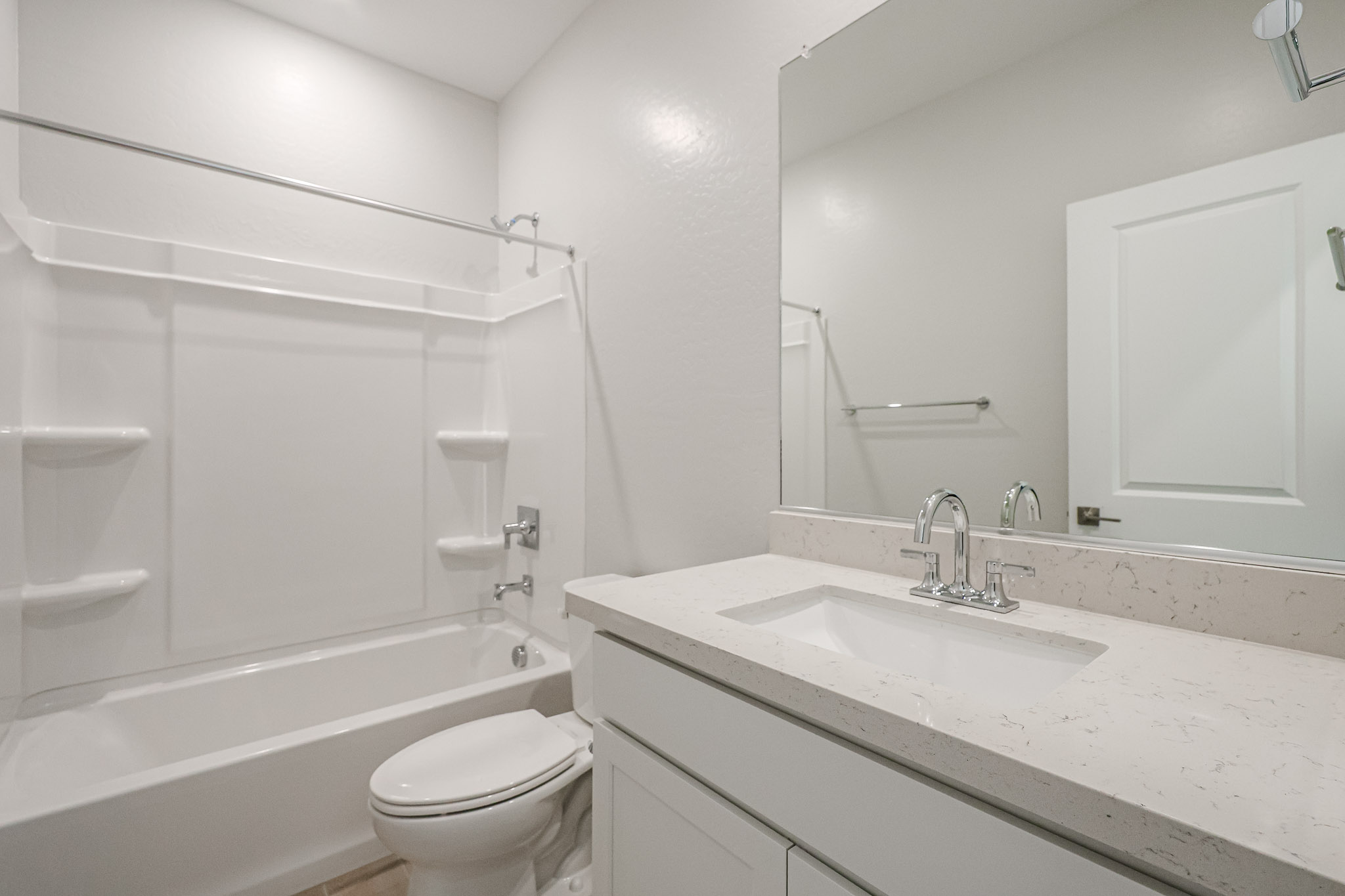 A bathroom with a sink toilet and bathtub.