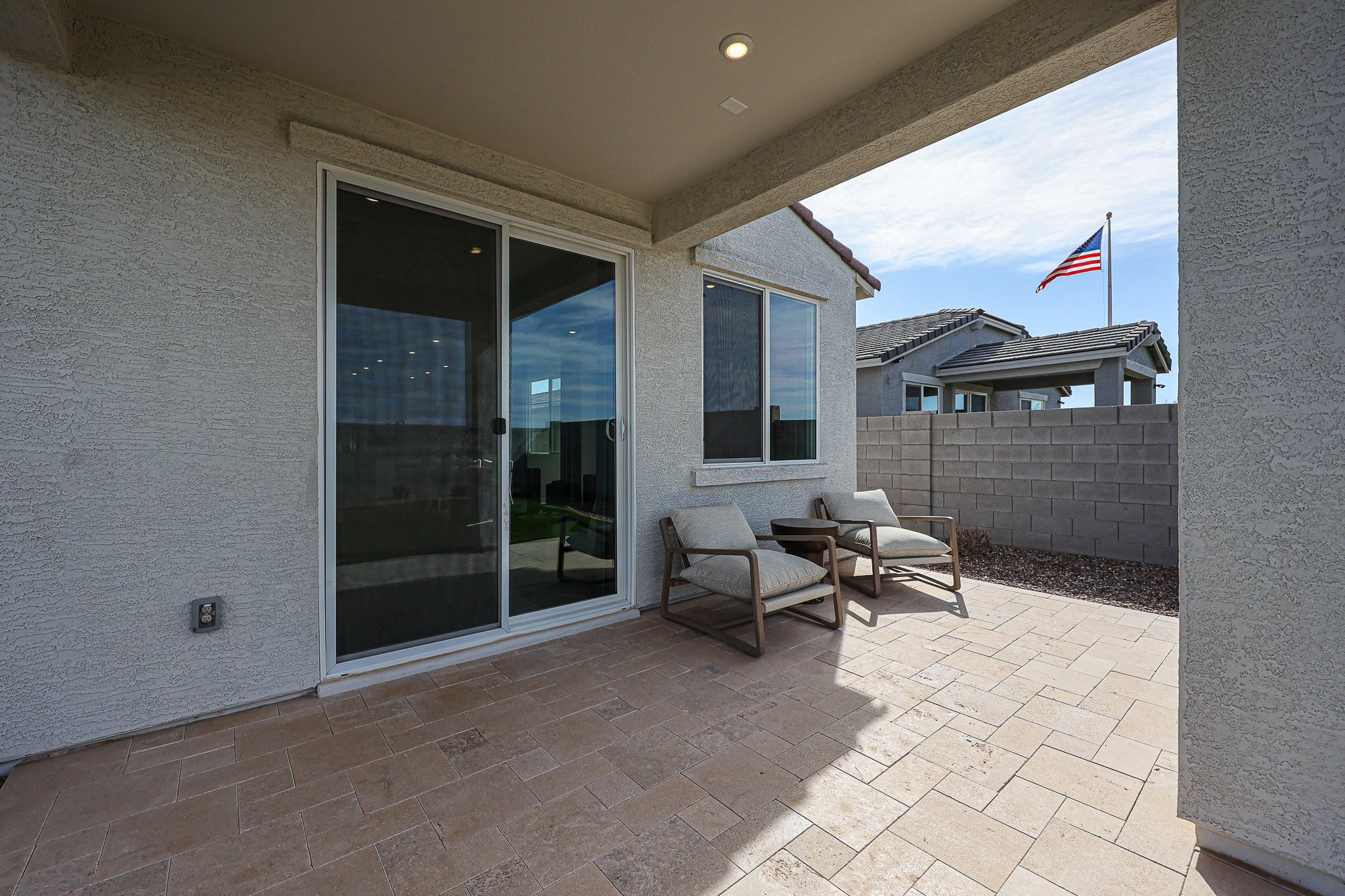 A patio with a table and chairs.