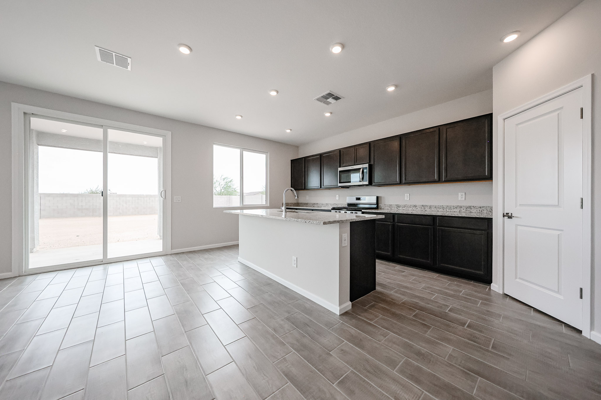 A kitchen with black cabinets.