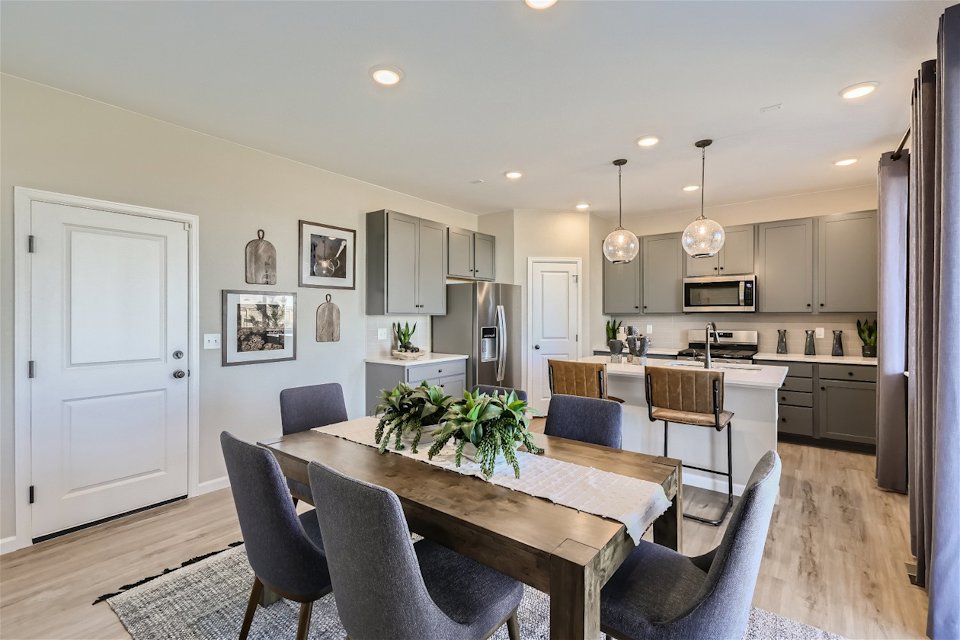 A kitchen with a dining table.