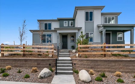 A house with a fence and stairs.