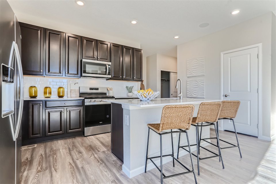 A kitchen with black cabinets.