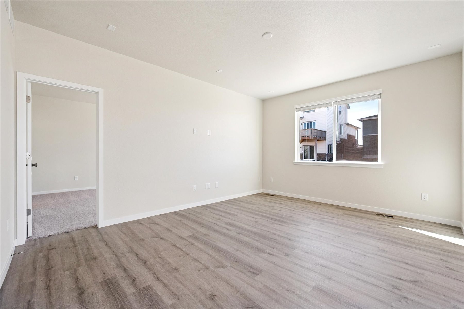 A room with a wood floor and a window.