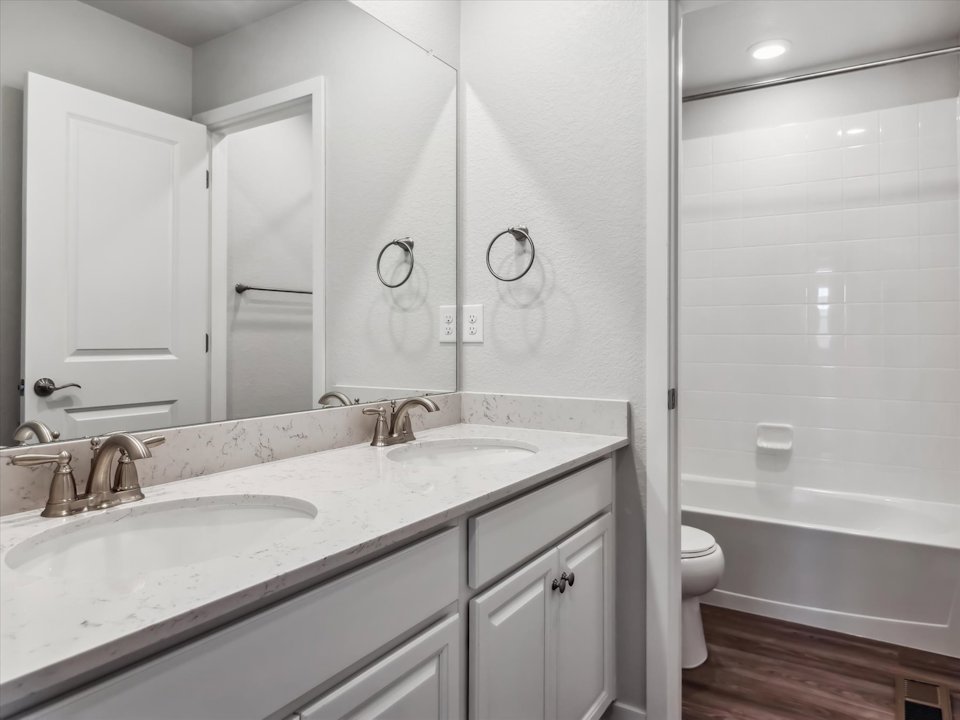 A bathroom with a sink toilet and bathtub.