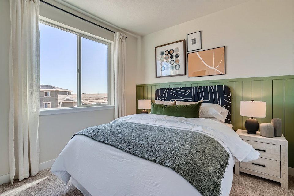 A bedroom with a large window.