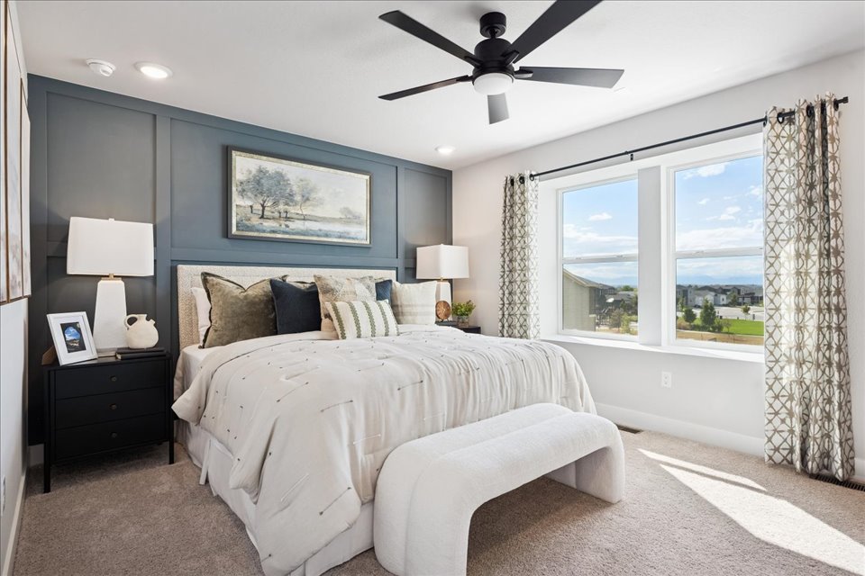 A bedroom with a large window.