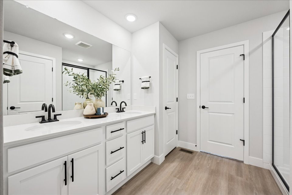 A bathroom with white cabinets.