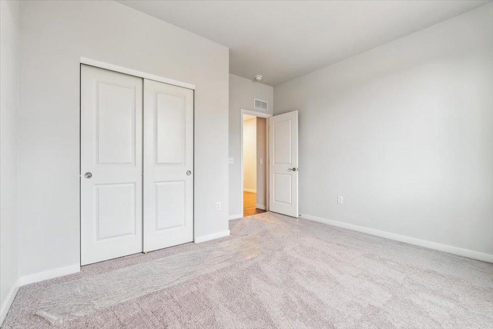 A hallway with white doors.
