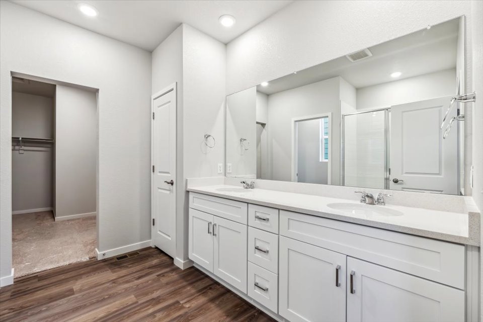 A bathroom with white cabinets.