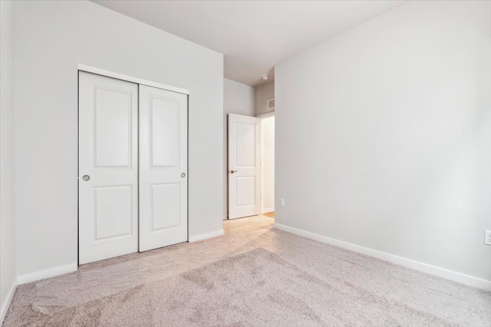 A hallway with white doors.