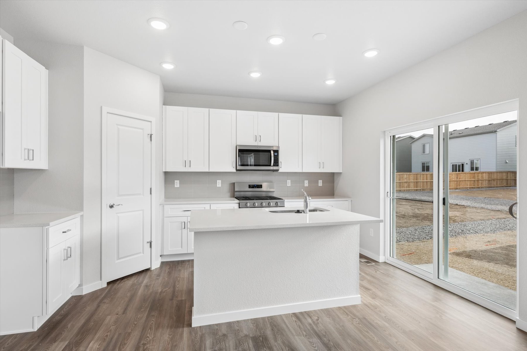 A kitchen with white cabinets.