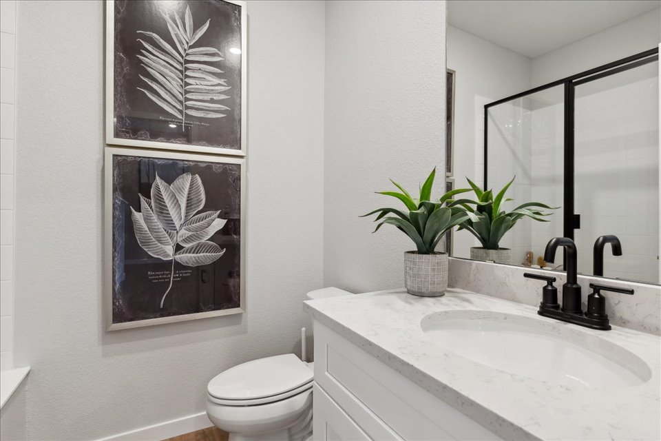 A bathroom with a sink and a toilet.