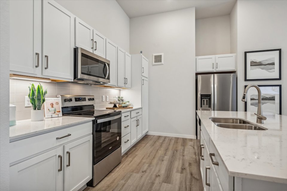 A kitchen with white cabinets.