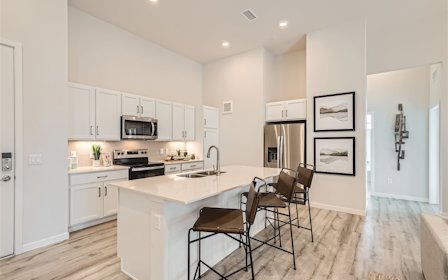 A kitchen with white cabinets.