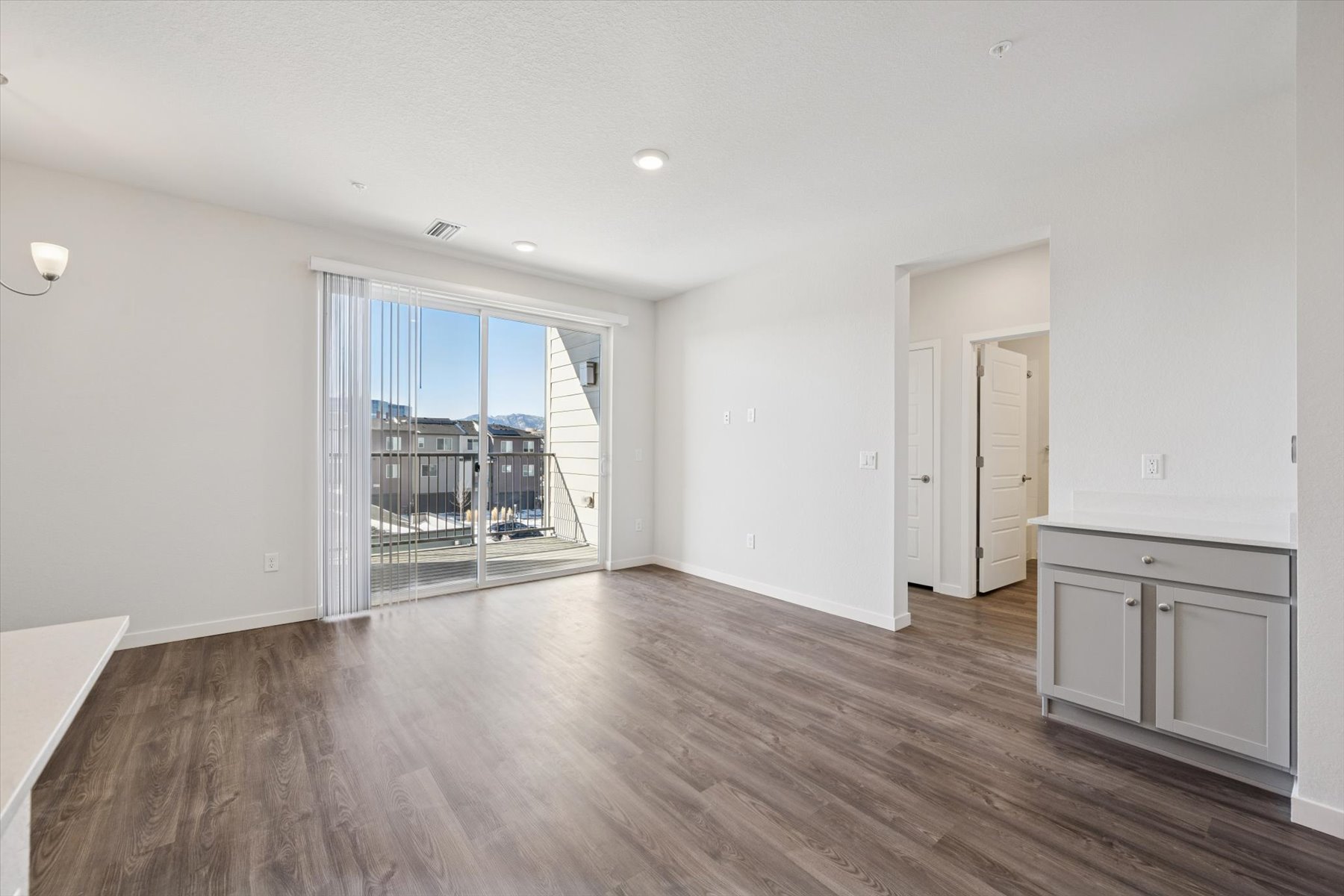 A room with white walls and a wood floor.