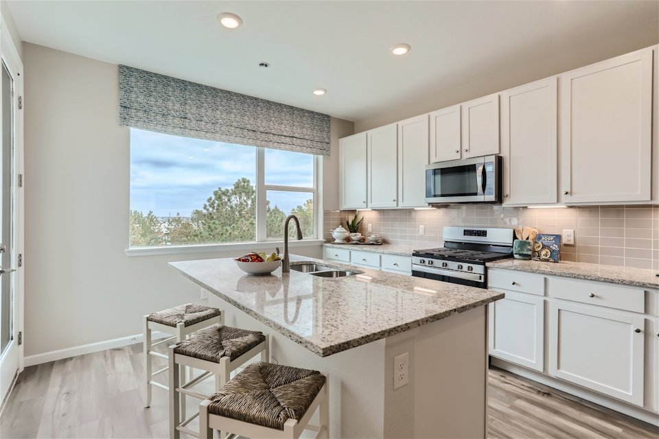 A kitchen with white cabinets.