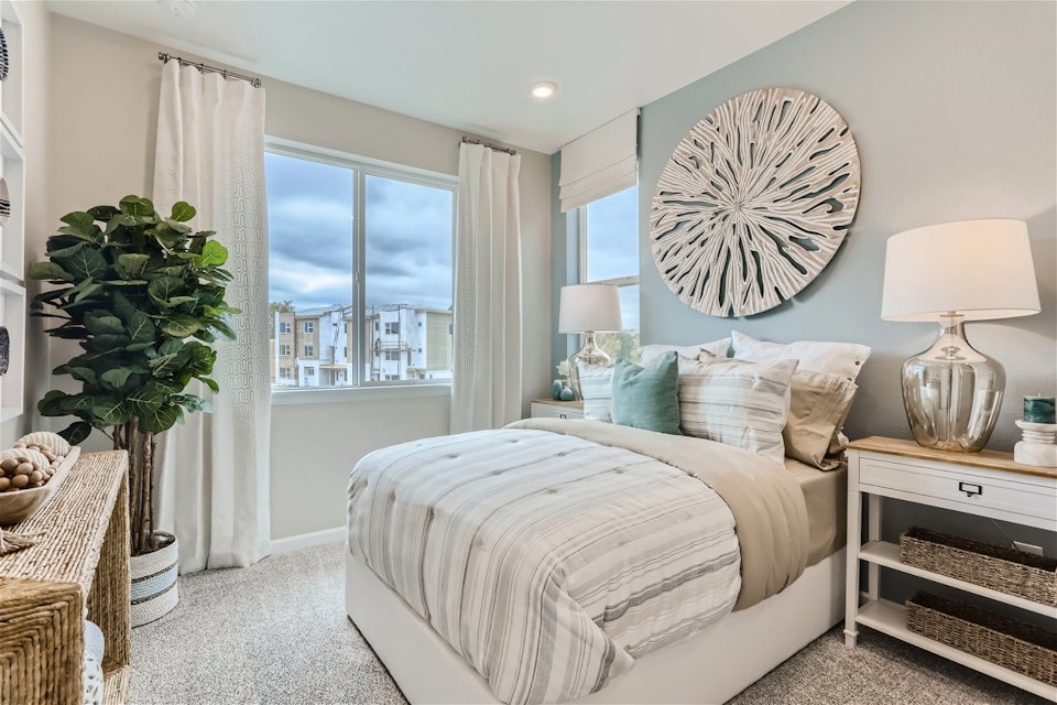 A bedroom with a large window.