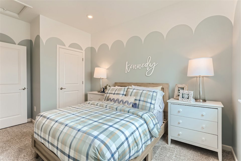 A bedroom with a bed and lamps.