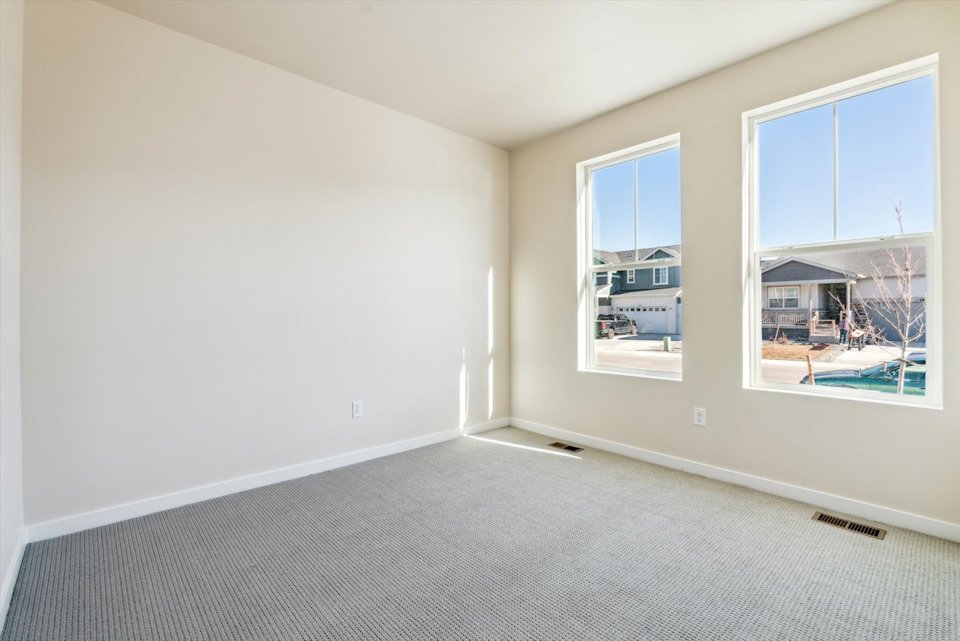 A room with a window and a view of the water.
