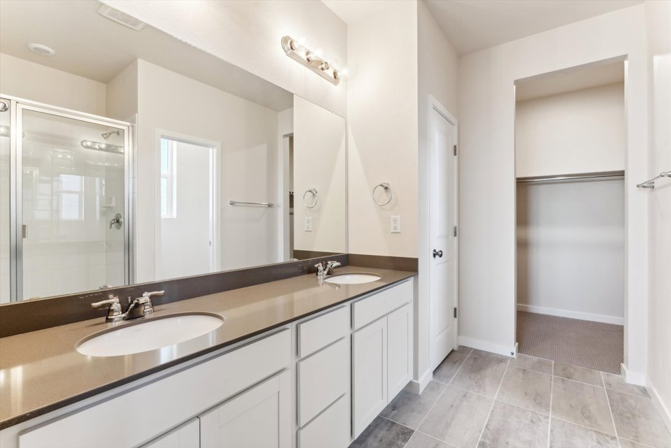 A bathroom with a large mirror.