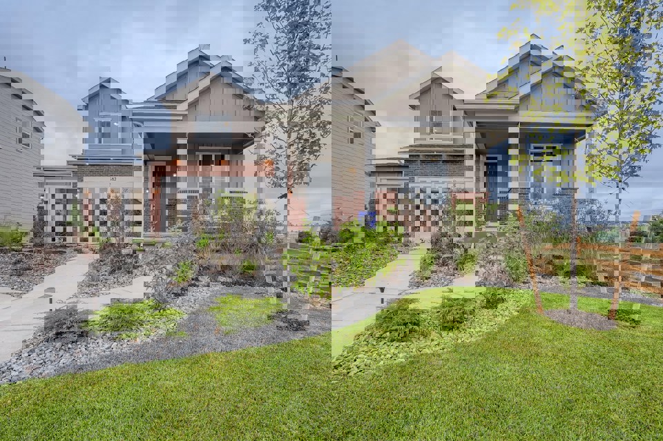 A house with a yard and a fence.